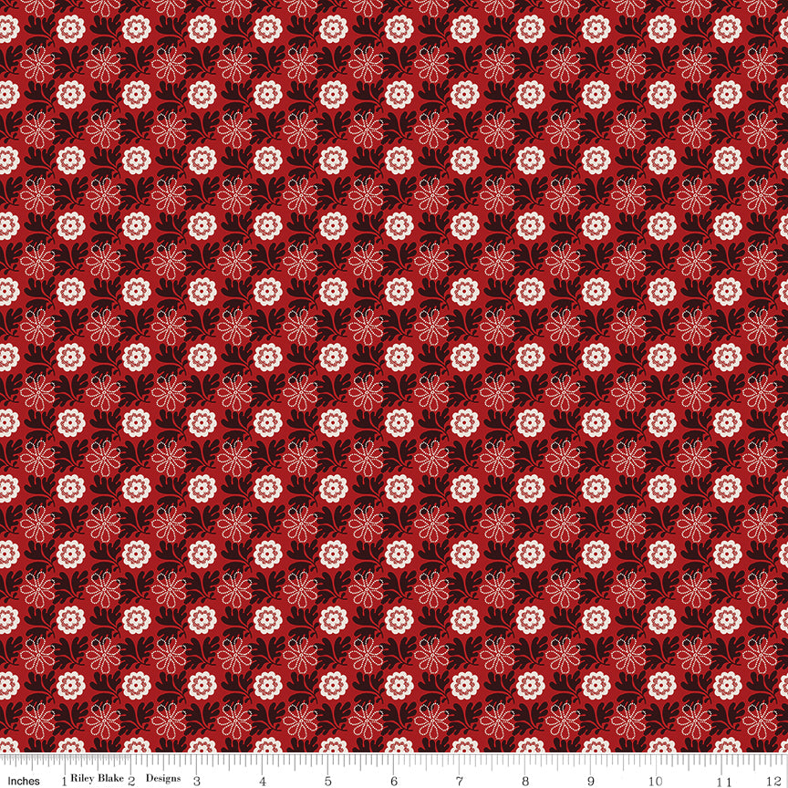 Northanger Abbey Captain fabric with cream and red flowers in a dense repeat on deep red with ruler for scale.