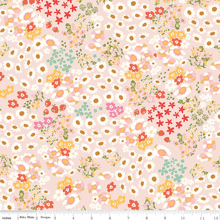 Cotton Nook Flowerbed Blush fabric with daisies, strawberries and mixed flowers on pale pink with ruler for scale.