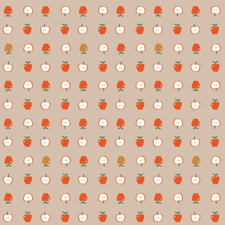 Cotton Nook Apples Biscuit fabric with red apples and sliced apples on a warm beige background.