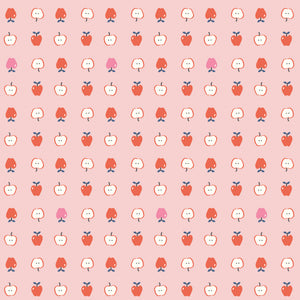 Cotton Nook Apples Pink fabric with red, pink and sliced apples arranged on a soft pink background.