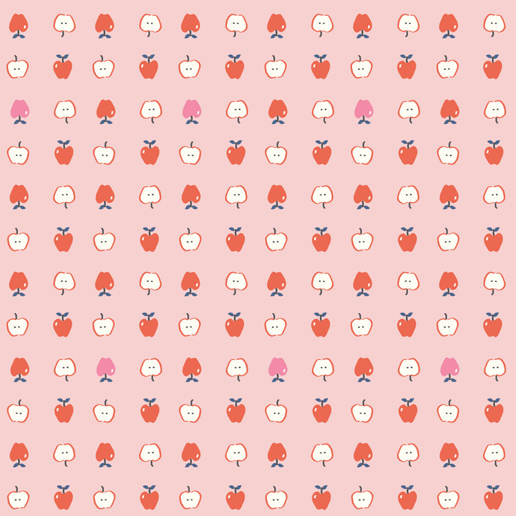 Cotton Nook Apples Pink fabric with red, pink and sliced apples arranged on a soft pink background.