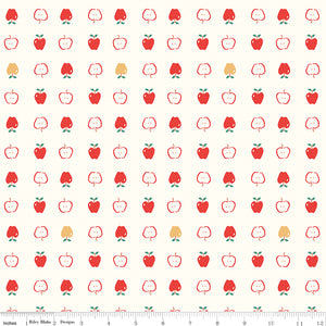 Cotton Nook Apples Vintage White fabric with red apples and apple slices on cream with ruler for scale.