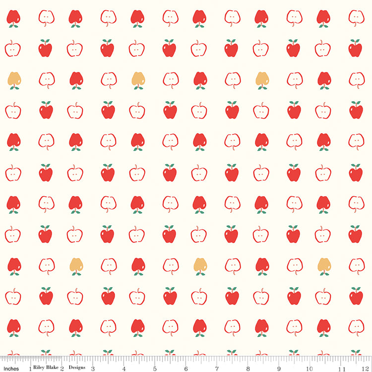 Cotton Nook Apples Vintage White fabric with red apples and apple slices on cream with ruler for scale.