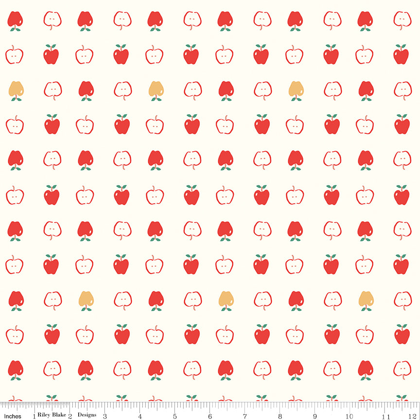 Cotton Nook Apples Vintage White fabric with red apples and apple slices on cream with ruler for scale.