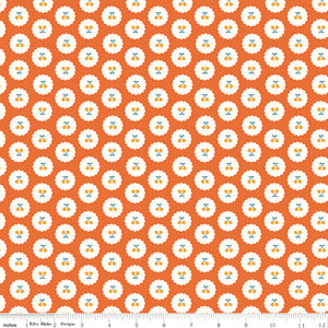 Cotton Nook Cherries Orange fabric with golden cherries in white scalloped circles on orange with ruler for scale.