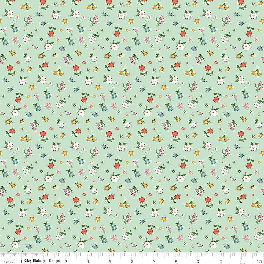 Cotton Nook Pretty Mint fabric with scattered colorful petite flowers on a soft mint green background with ruler for scale.