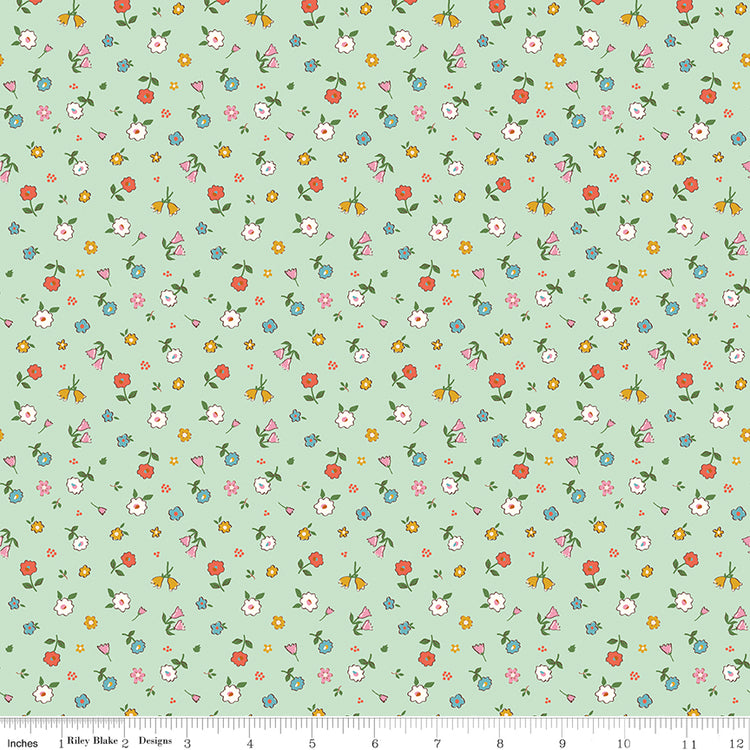Cotton Nook Pretty Mint fabric with scattered colorful petite flowers on a soft mint green background with ruler for scale.