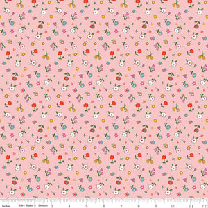 Cotton Nook Pretty Pink fabric with tiny colorful flowers and leafy sprigs on a soft pink background with ruler for scale.