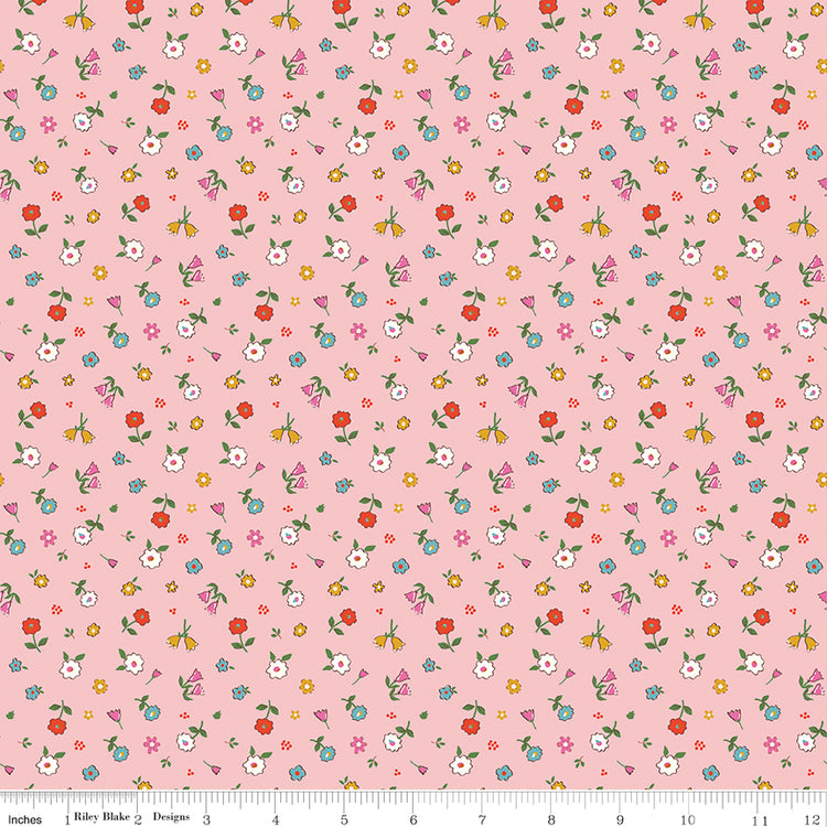 Cotton Nook Pretty Pink fabric with tiny colorful flowers and leafy sprigs on a soft pink background with ruler for scale.