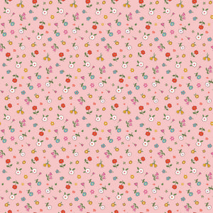Cotton Nook Pretty Pink fabric with tiny colorful flowers and leafy sprigs on a soft pink background.