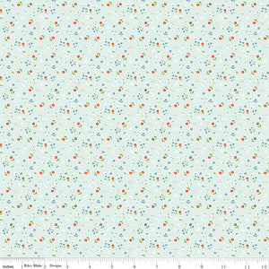 Cotton Nook Flowers Bleached Denim fabric with tiny floral sprigs on a pale blue background with ruler for scale.