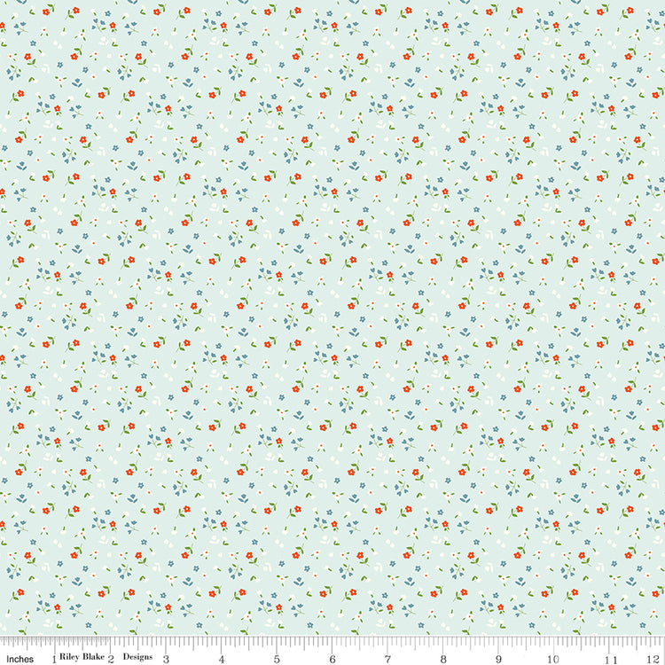 Cotton Nook Flowers Bleached Denim fabric with tiny floral sprigs on a pale blue background with ruler for scale.
