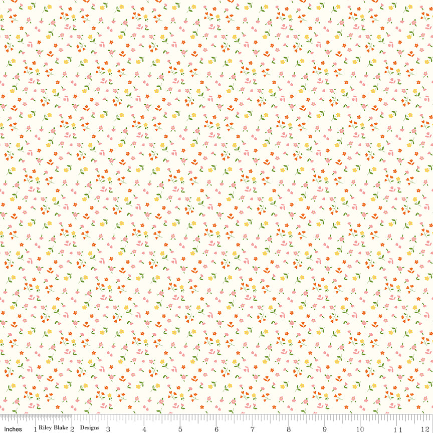 Cotton Nook Flowers Vintage White fabric with tiny pink, orange and yellow floral sprigs with ruler for scale.