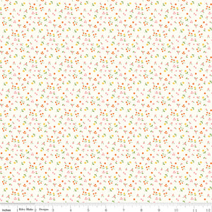Cotton Nook Flowers Vintage White fabric with tiny pink, orange and yellow floral sprigs with ruler for scale.