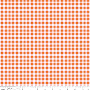 Cotton Nook Plaid Orange fabric with orange, blush pink and cream gingham checks with ruler for scale.
