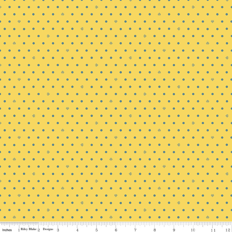Cotton Nook Dots Yellow fabric with small blue-gray dots scattered across a sunny yellow background with ruler for scale.