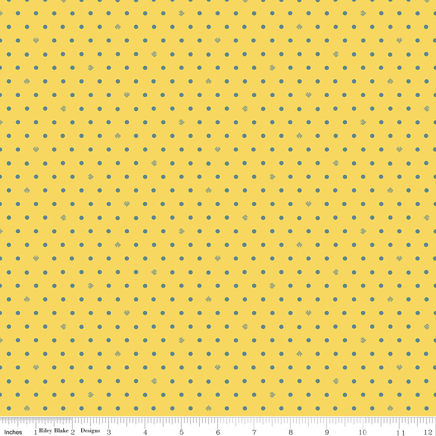 Cotton Nook Dots Yellow fabric with small blue-gray dots scattered across a sunny yellow background with ruler for scale.