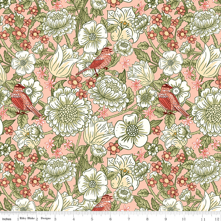 Blush pink floral fabric with cream flowers, green leaves, and coral birds with a ruler along the bottom for scale. 