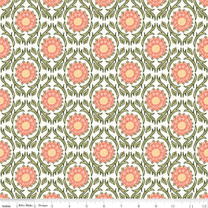 Cream fabric with repeating pink floral medallions and olive green vines with a ruler at the bottom for scale. 