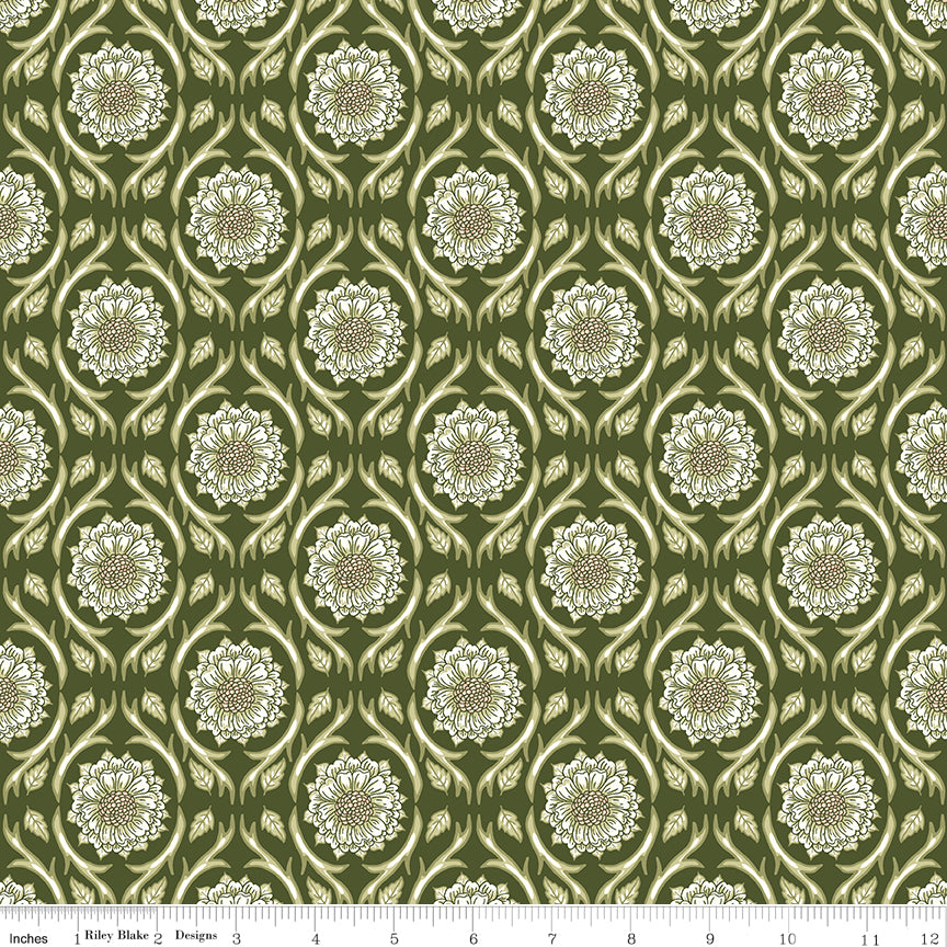 Hunter green fabric with repeating cream floral medallions and leafy vines with a ruler for scale at the bottom