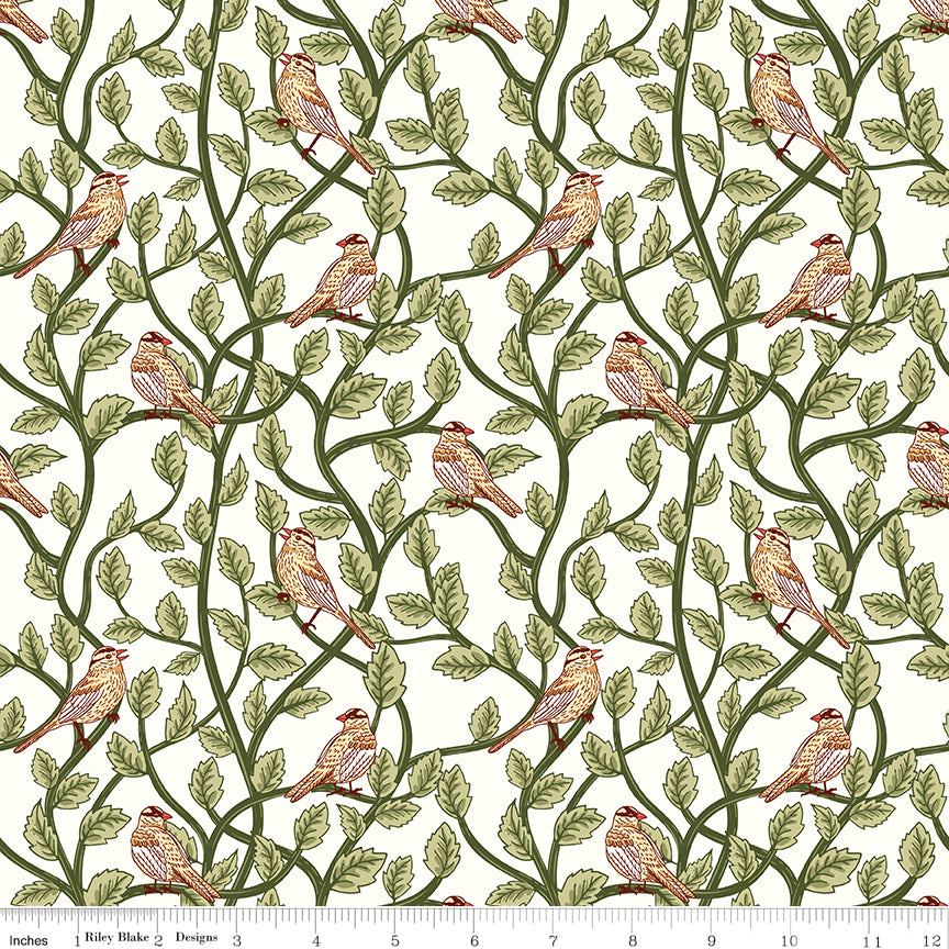 Cream fabric with small birds perched among winding green leafy branches and a ruler at the bottom for scale.