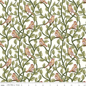 Cream fabric with small birds perched among winding green leafy branches and a ruler at the bottom for scale.