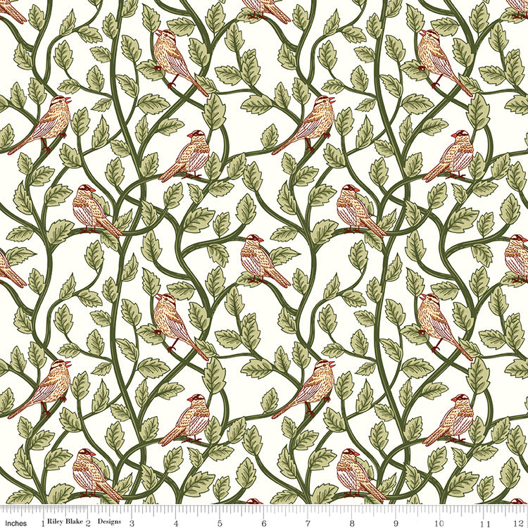 Cream fabric with small birds perched among winding green leafy branches and a ruler at the bottom for scale.