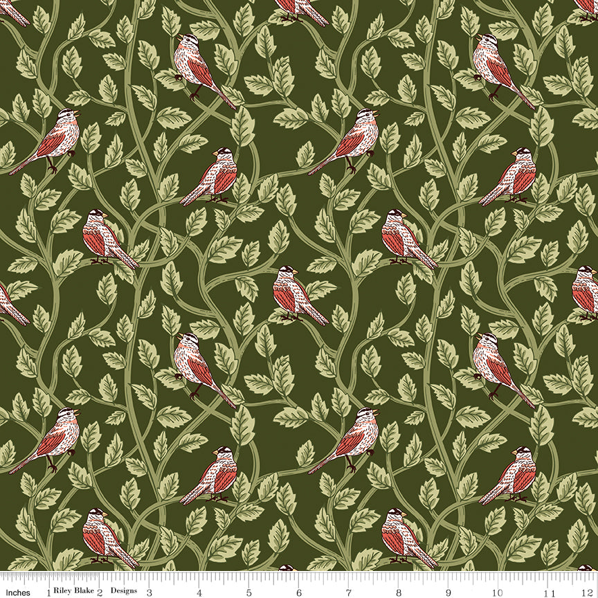 Hunter green fabric with red and cream birds among winding leafy branches and a ruler at the bottom for scale. 
