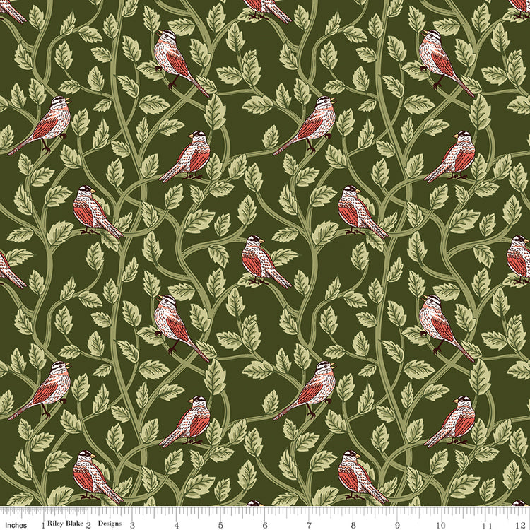 Hunter green fabric with red and cream birds among winding leafy branches and a ruler at the bottom for scale. 