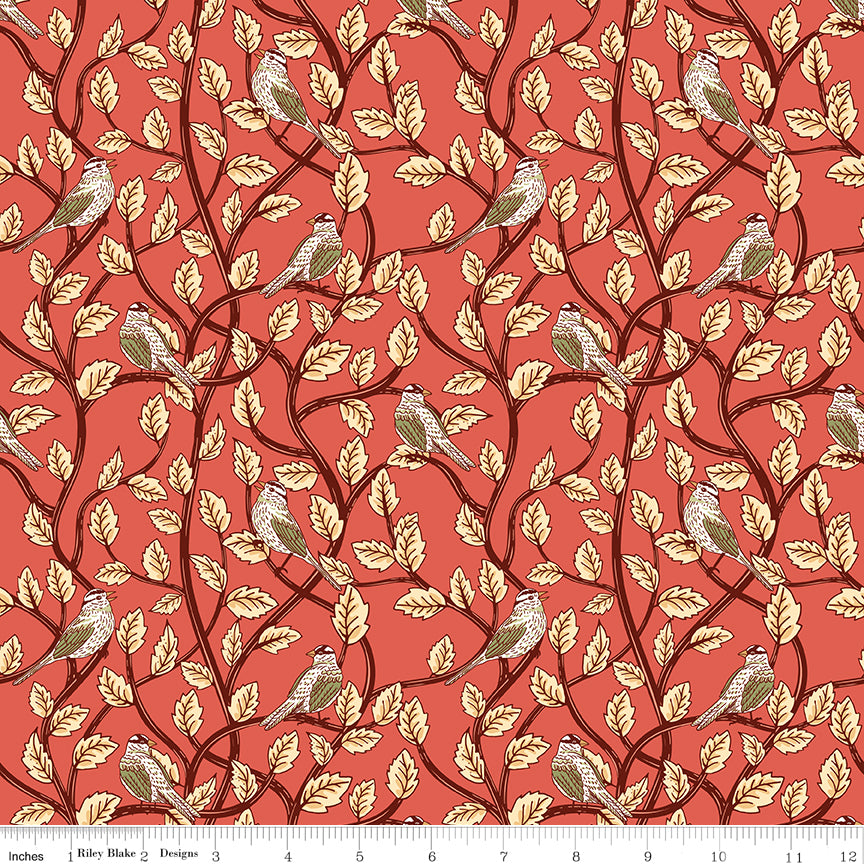 Sunset coral fabric with birds perched among cream leaves and dark winding branches with a ruler along the bottom for scale. 