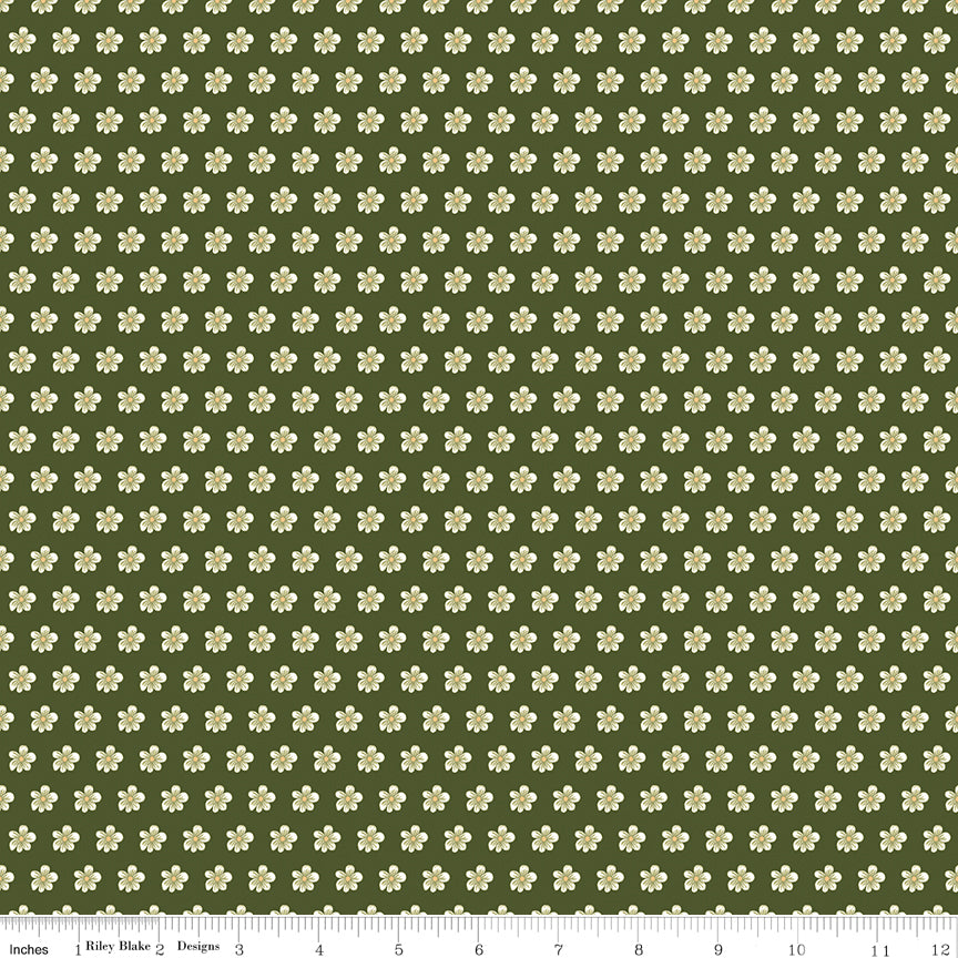 Hunter green fabric with evenly spaced small cream flowers and a ruler for scale