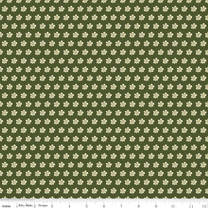 Hunter green fabric with evenly spaced small cream flowers and a ruler for scale