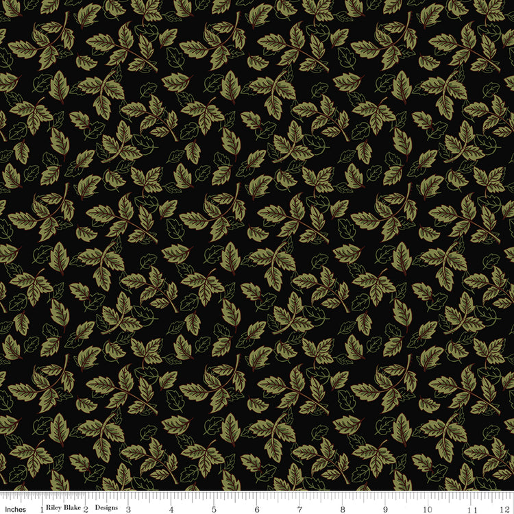 Black fabric with scattered olive green leafy sprigs and a ruler along the bottom for scale. 