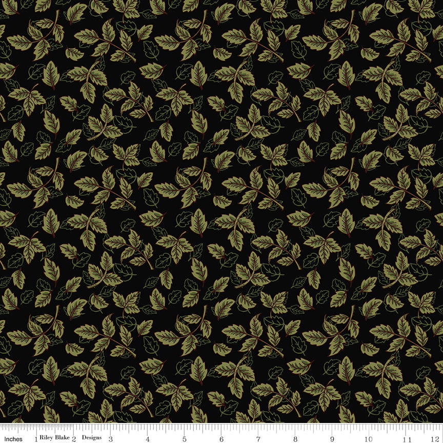 Black fabric with scattered olive green leafy sprigs and a ruler along the bottom for scale. 