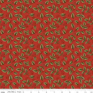 Red fabric with scattered olive green leafy sprigs and a ruler for scale