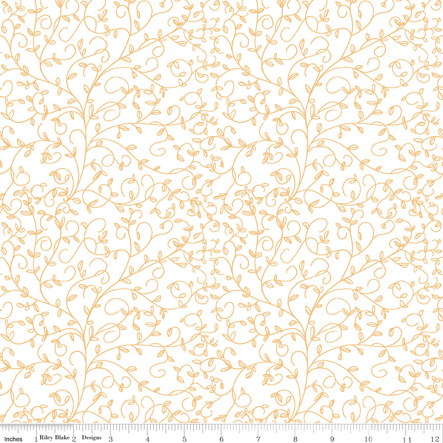 Cream fabric with delicate golden curling vines and tiny leaves, ruler at the bottom for scale