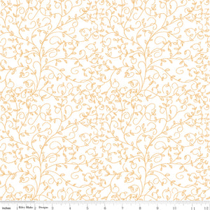 Cream fabric with delicate golden curling vines and tiny leaves, ruler at the bottom for scale