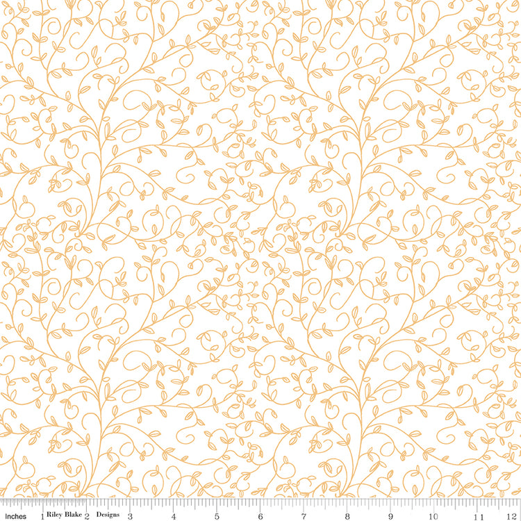 Cream fabric with delicate golden curling vines and tiny leaves, ruler at the bottom for scale