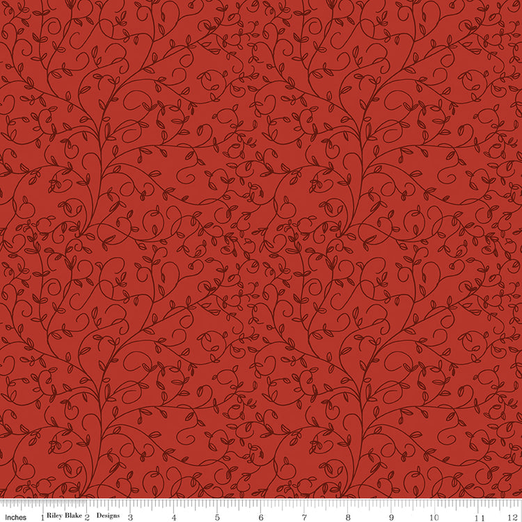 Red fabric with dark tonal curling vines and tiny leaves and a ruler along the bottom for scale.