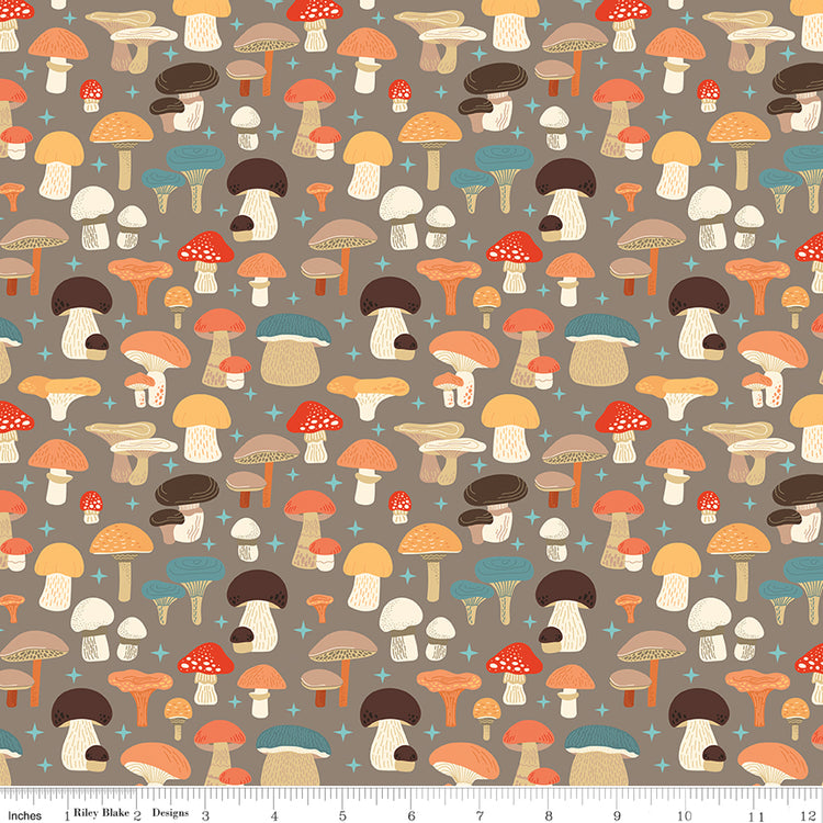 A repeating pattern of illustrated mushrooms in warm autumn colors on a taupe background, with a small ruler strip along the bottom edge showing scale.