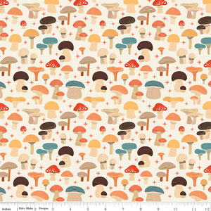 A repeating mushroom pattern on a cream background, with small red plus signs between the motifs. The mushrooms are shown in muted autumn tones including orange, brown, teal-blue, and beige. Ruler for scale.