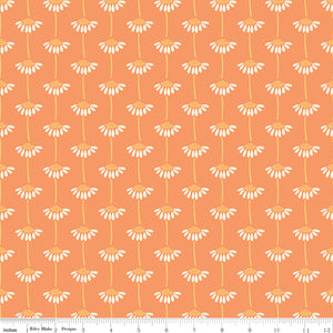 Fabric with small white floral pattern on an orange background. Ruler along the bottom for scale. 