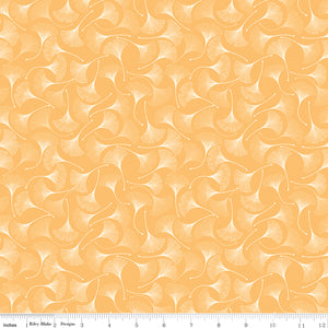 A repeating pattern of white ginkgo leaves on a warm peach-orange background, shown as a fabric or wallpaper design with a ruler at the bottom indicating scale.