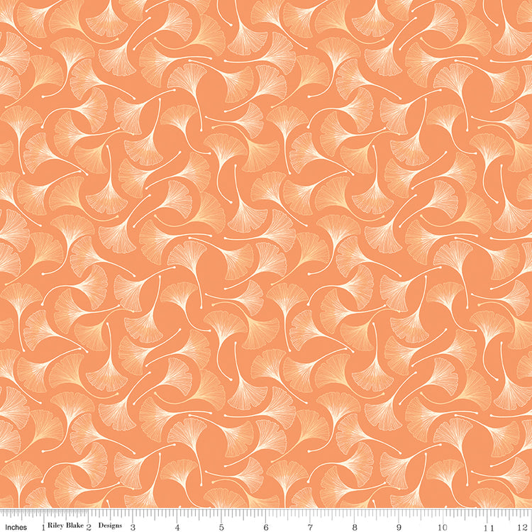A repeating pattern of stylized ginkgo leaves in peach, orange, and cream, shown as a fabric or paper swatch with a ruler along the bottom for scale.