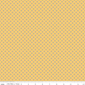 A repeating fabric pattern of small white floral clusters on a turquoise background, with a ruler along the bottom edge showing scale.