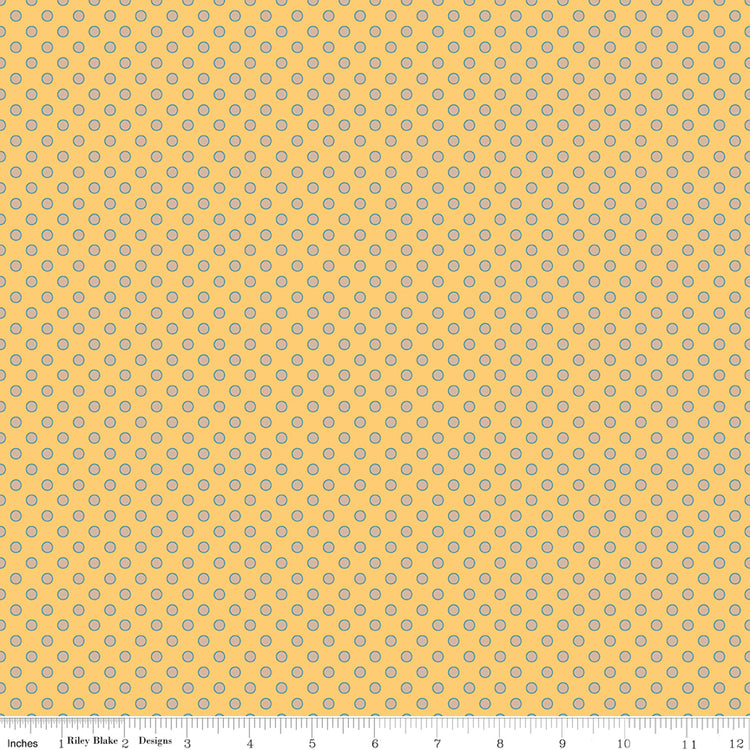 A repeating fabric pattern of small white floral clusters on a turquoise background, with a ruler along the bottom edge showing scale.