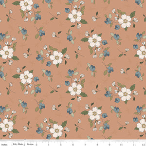Main Light Clay fabric with cream blossoms, dusty blue flowers, and olive leaves on a warm clay background with ruler for scale.