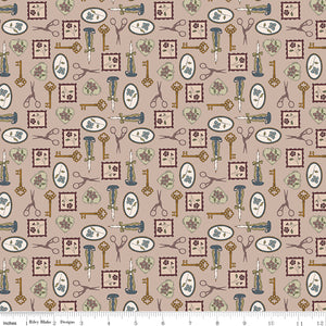Charmed Doe fabric with keys, scissors, candlesticks, floral frames, and heart charms on rosy taupe with ruler for scale.