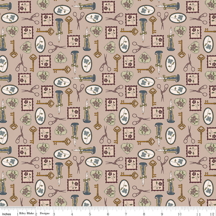 Charmed Doe fabric with keys, scissors, candlesticks, floral frames, and heart charms on rosy taupe with ruler for scale.