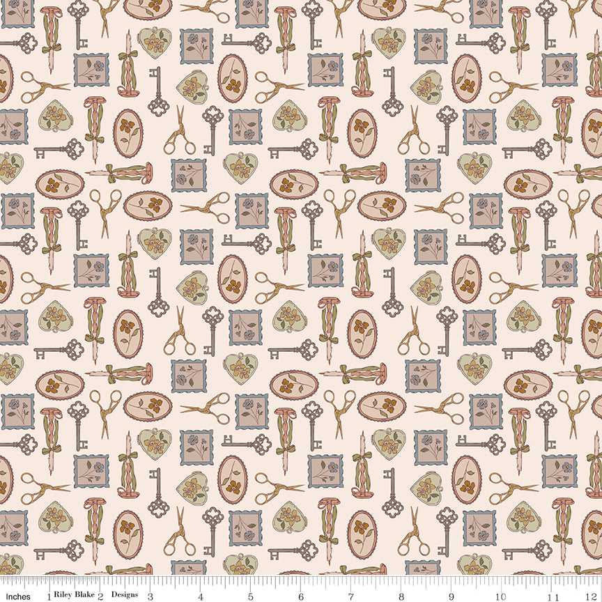 Charmed Latte fabric with decorative keys, scissors, candlesticks, floral frames, and hearts on cream with ruler for scale.